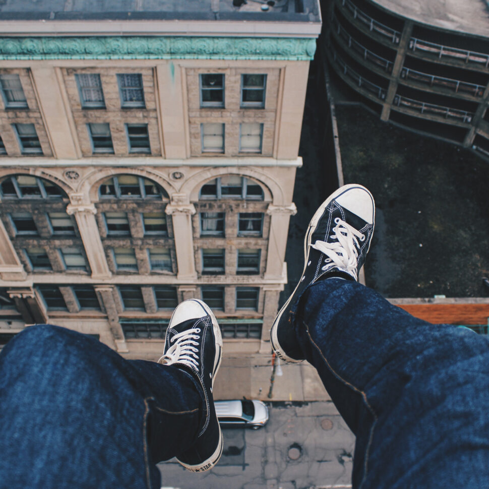 First-person perspective of sitting on the edge of a building